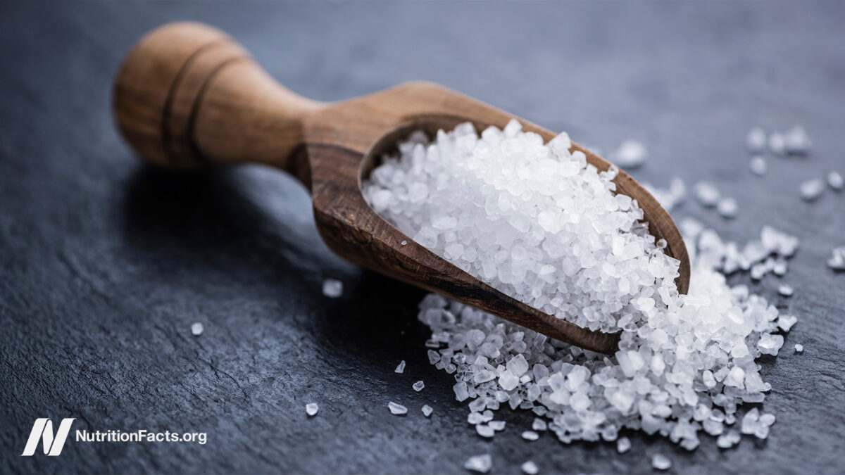 wooden scoop spoon with salt grains