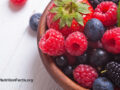 Mixed fresh berries in a wooden bowl