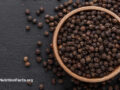 Bowl of whole black peppercorns