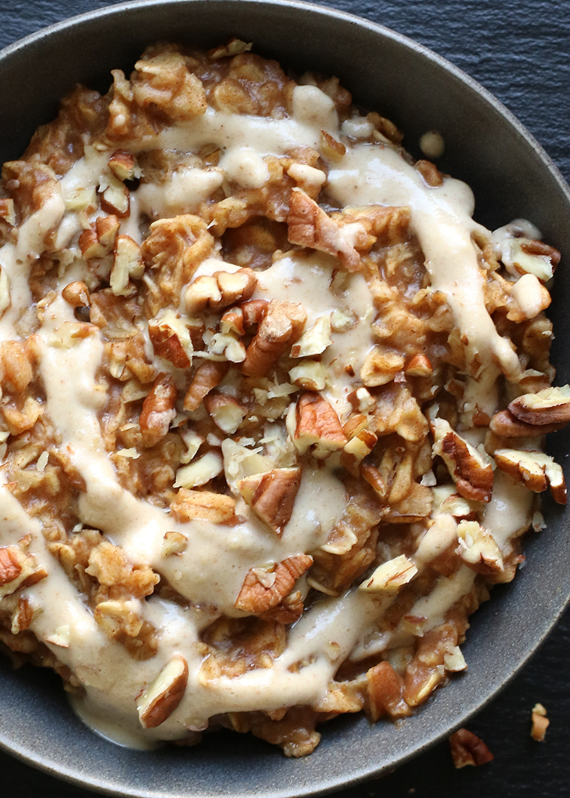 bowl of oatmeal topped with a drizzle and crushed nuts