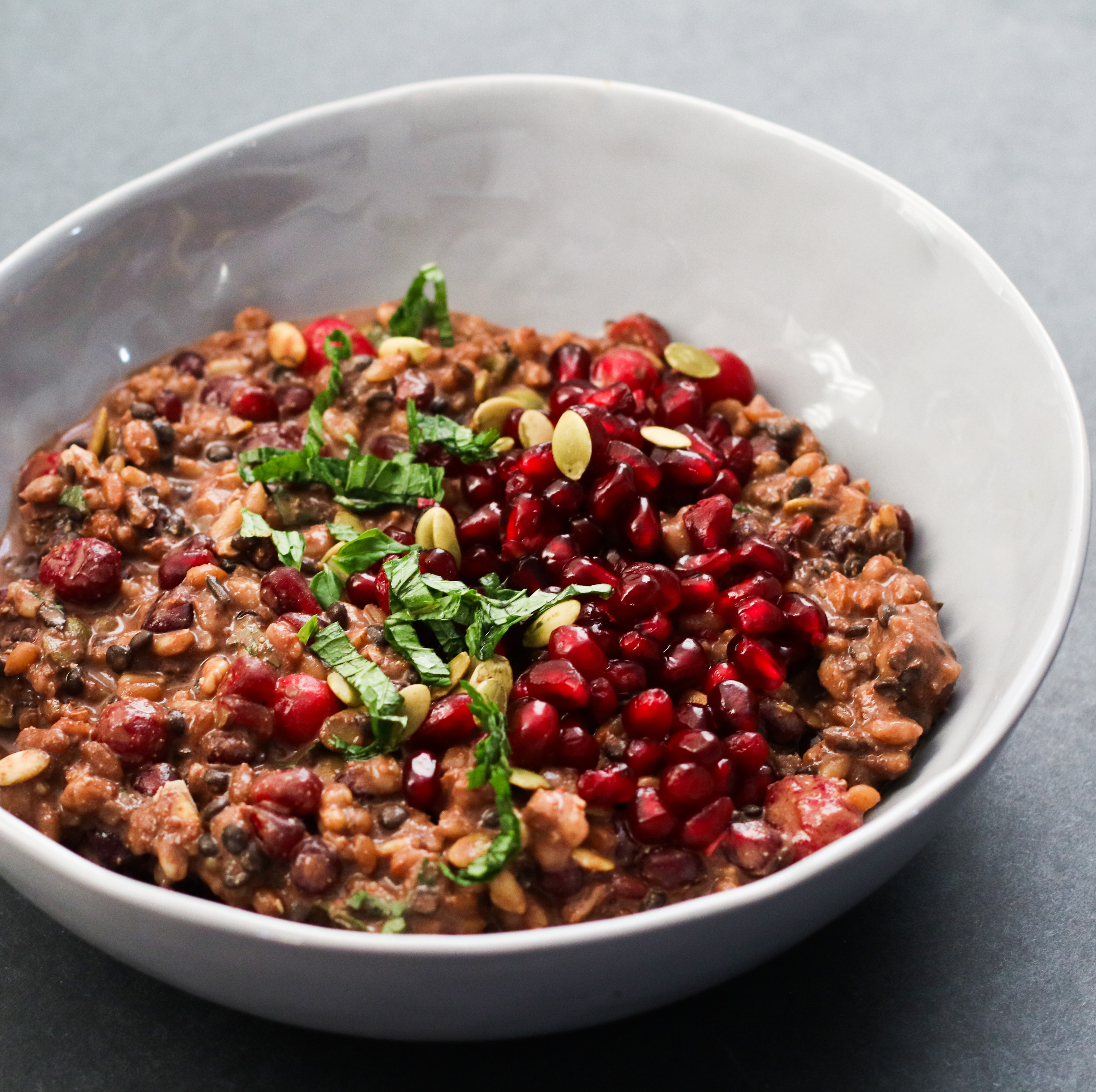 bowl of cranberry-chocolate BROL topped with pomegranate