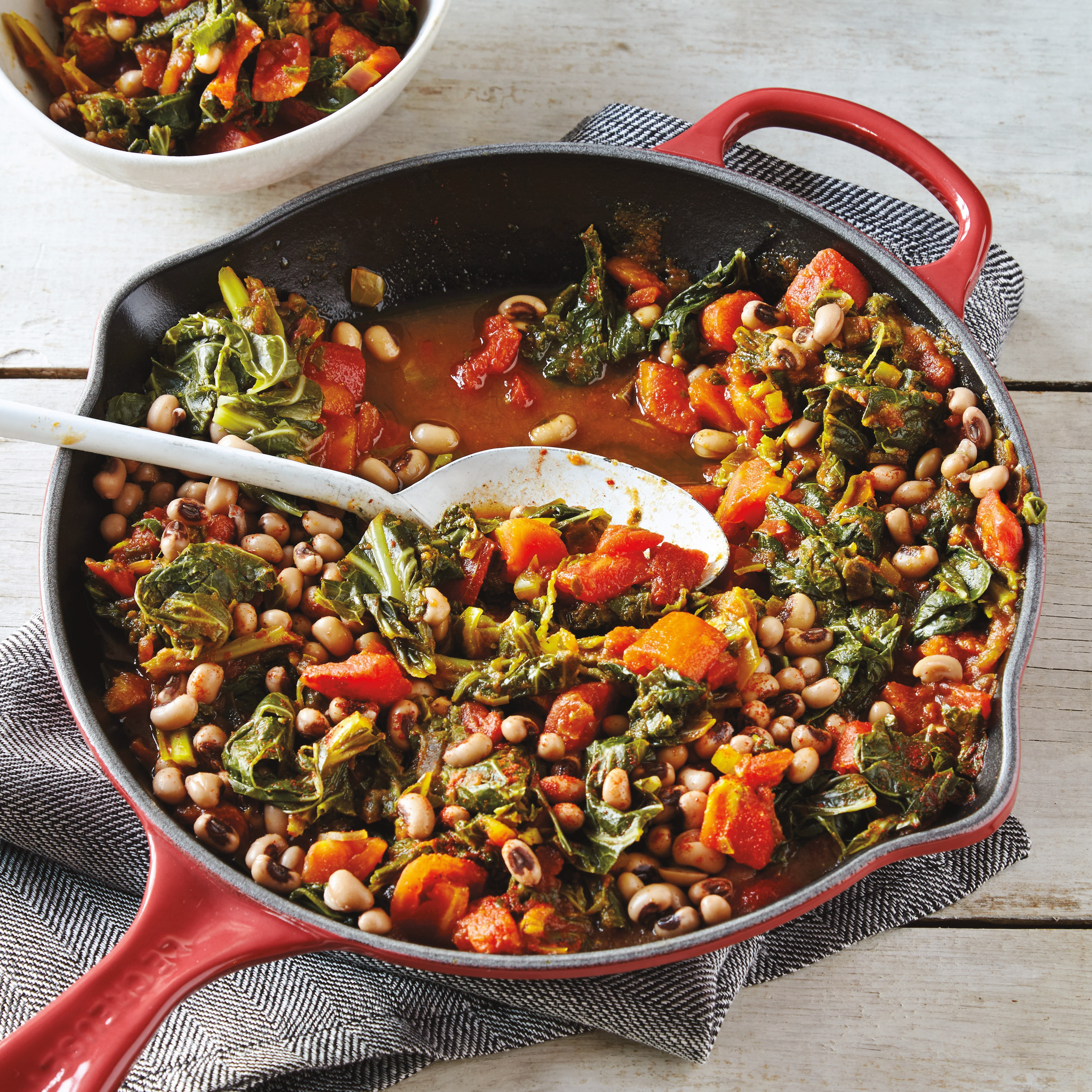 skillet and bowl of black-eyed pea and vegetable stew