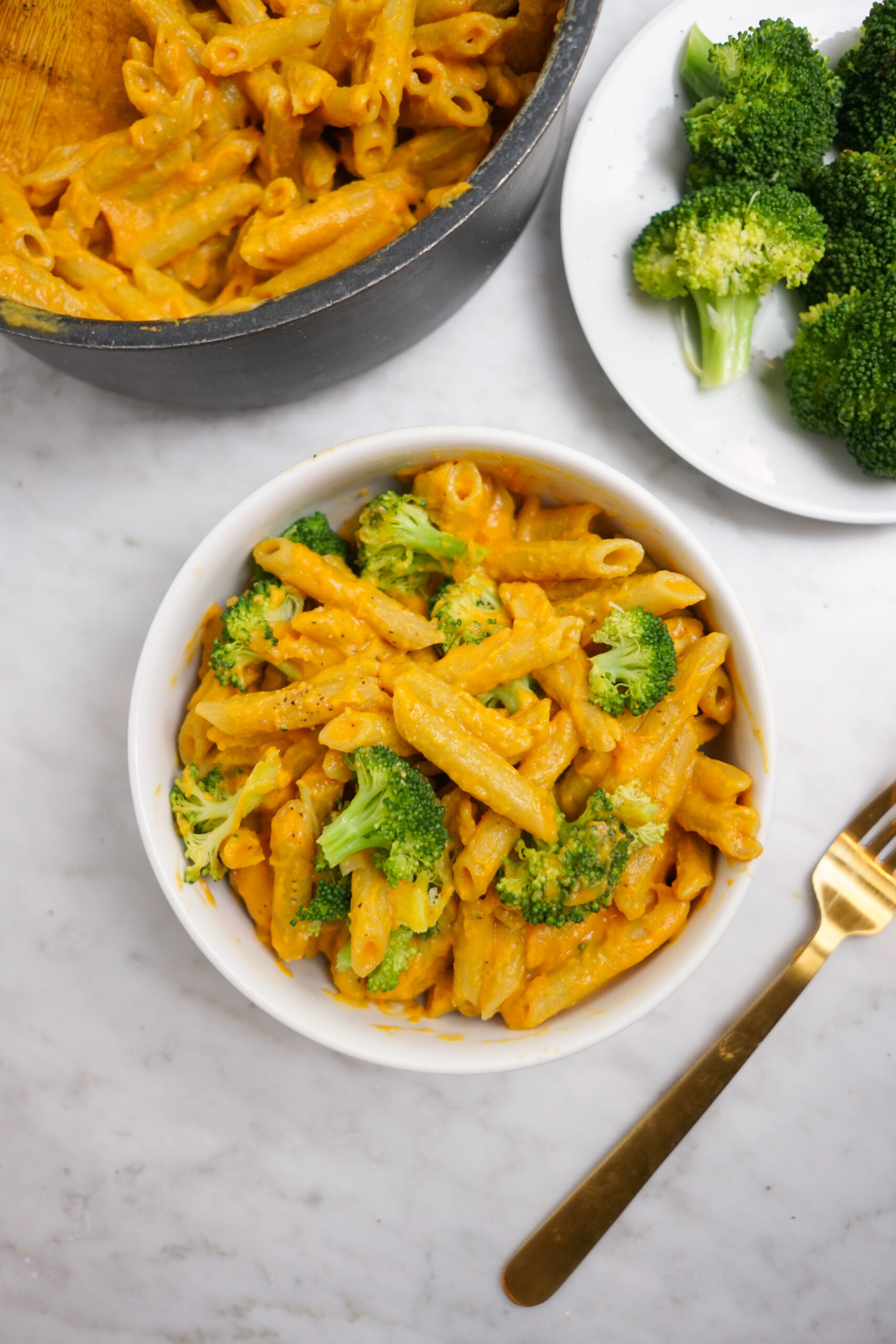 serving dish and bowl of sweet potato mac n cheese and broccoli florets