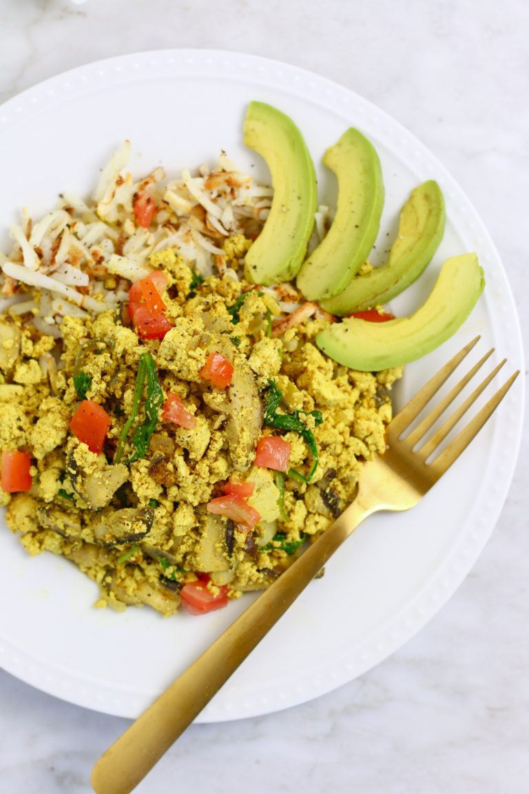 plate of tofu scramble and sliced avocado