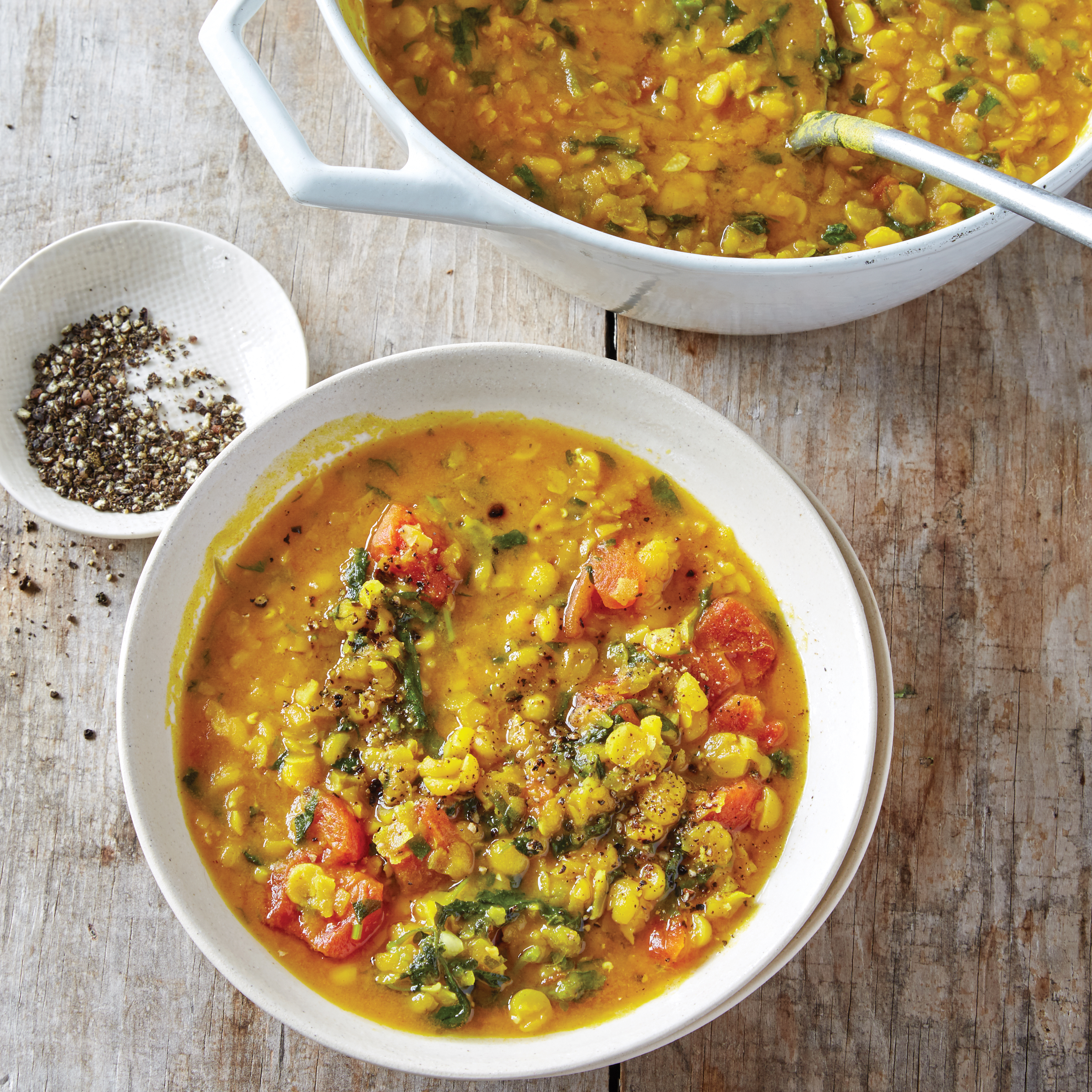 pot and bowl filled with yellow split pea dal