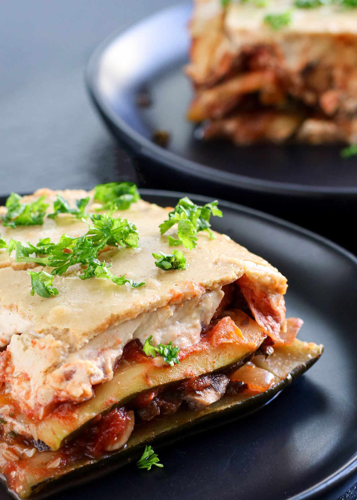 slice of zucchini lasagna topped with parsley