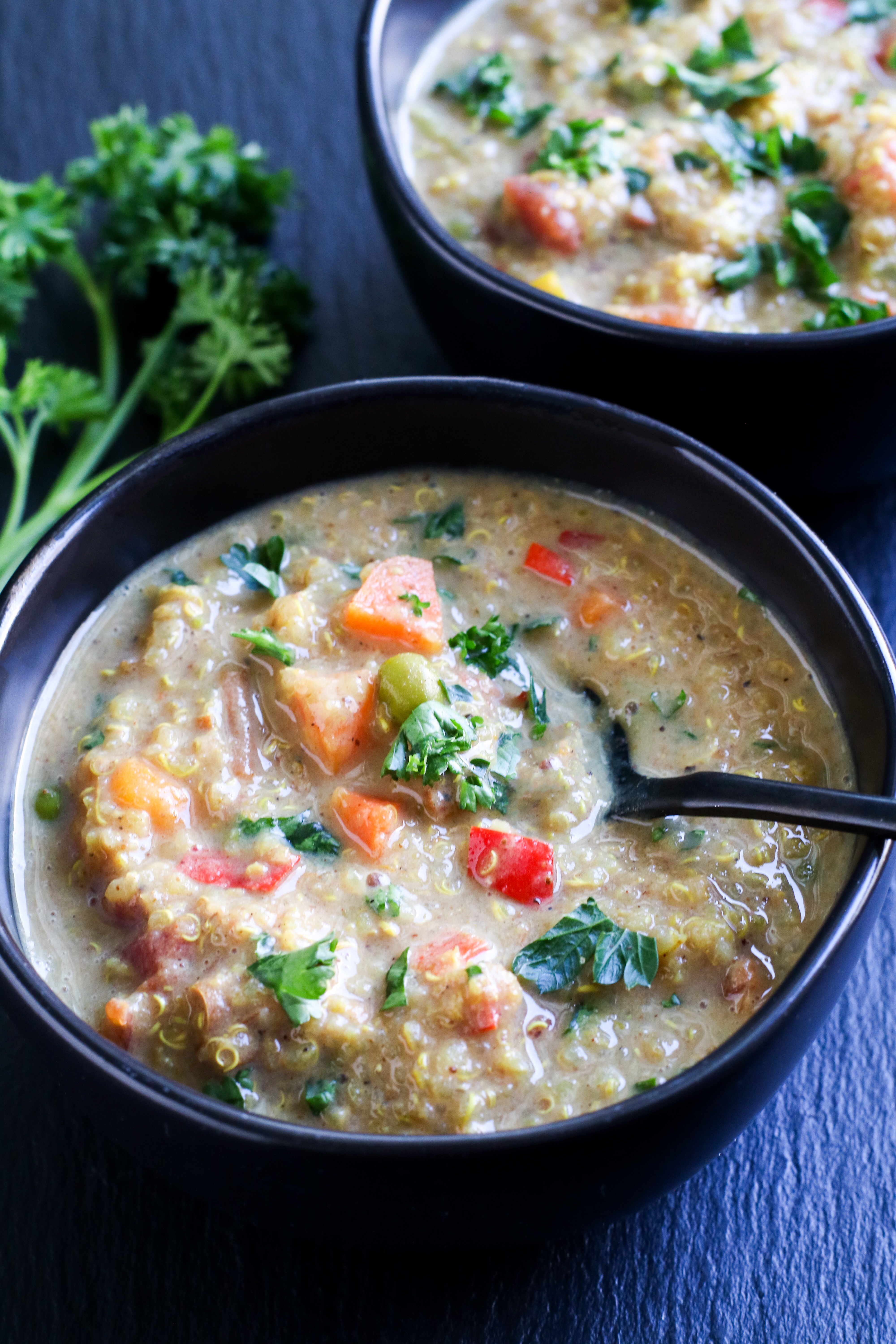 black bowls filled with quinoa and vegetable stew